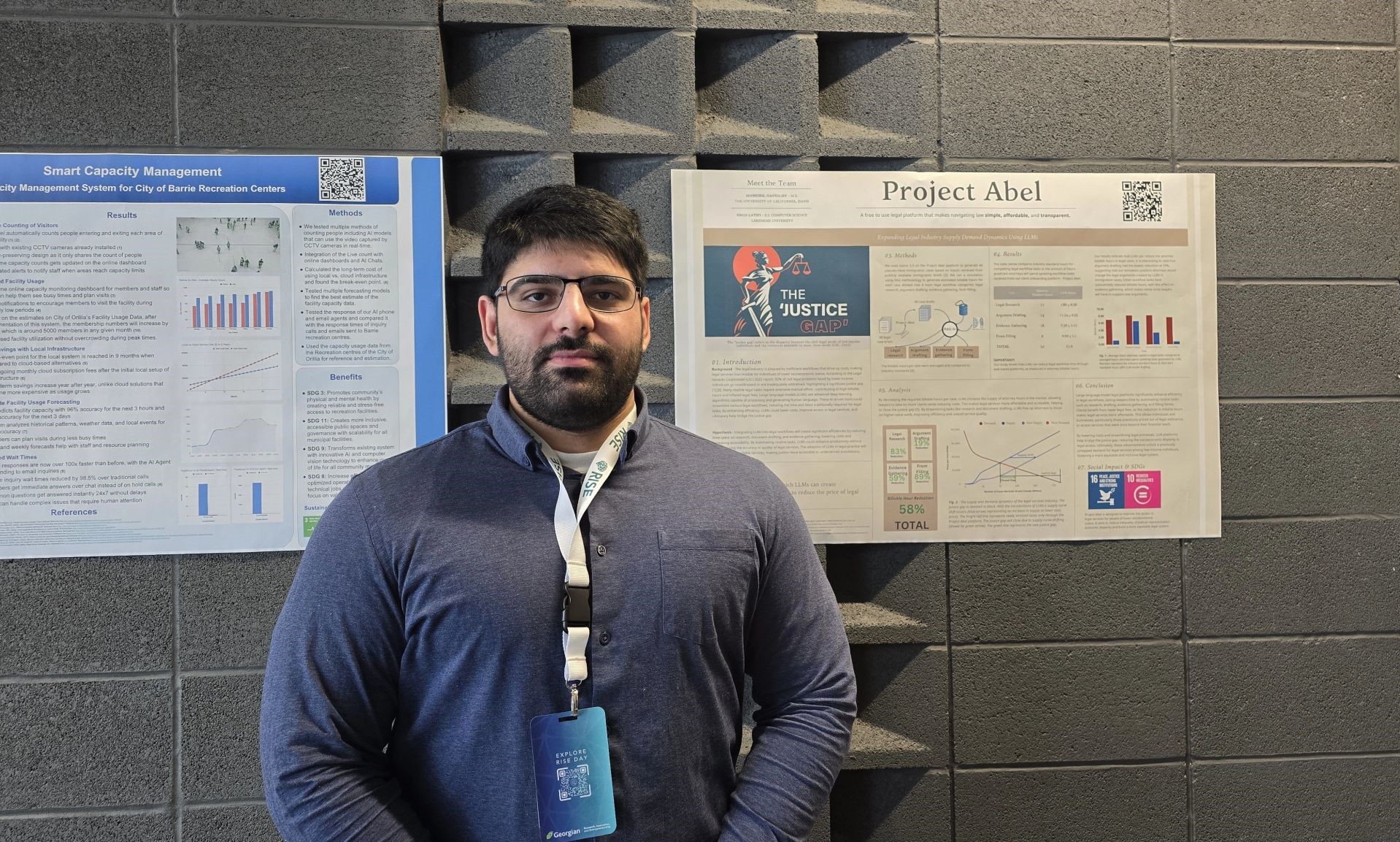 Lakehead-Georgian Computer Science Student Omid Latifi Omid Latifi stands in front of posters of his Smart Capacity Management and Project Abel posters