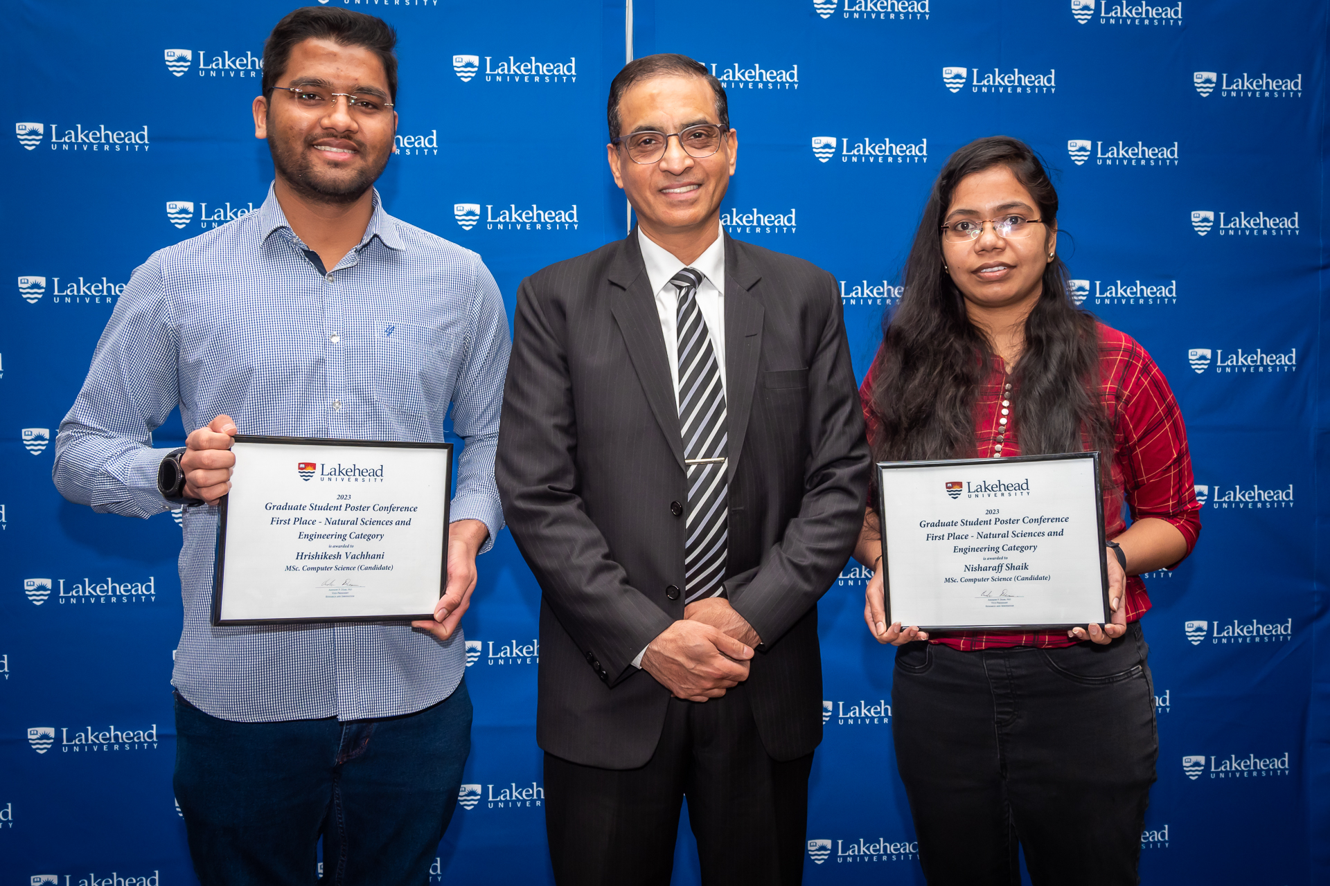 Photo of Dr. Chander Shahi, Dean, Faculty of Graduate Studies, with two graduate student award winners