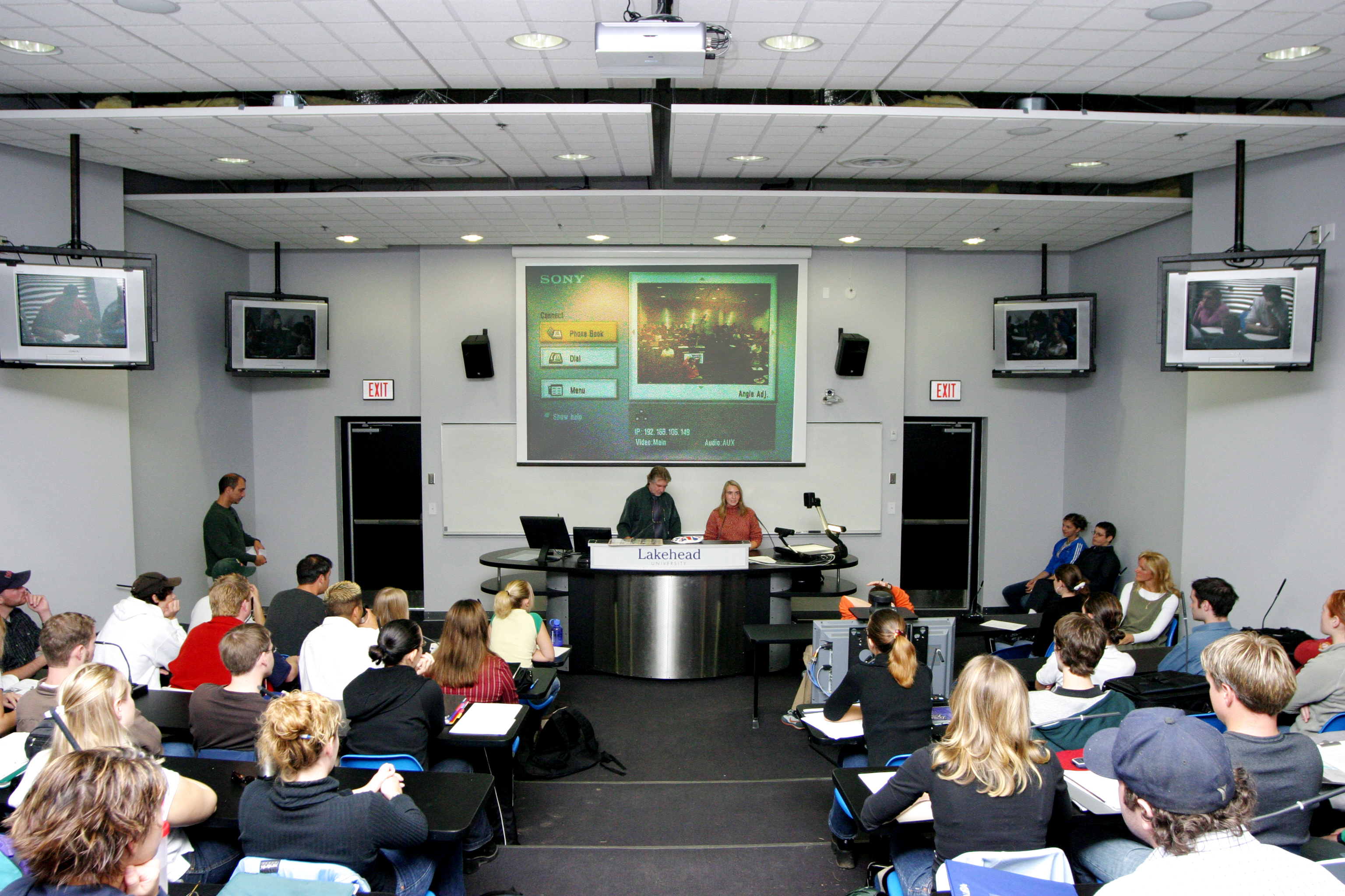 Multimedia classroom with class in session displaying use of multimedia equipment