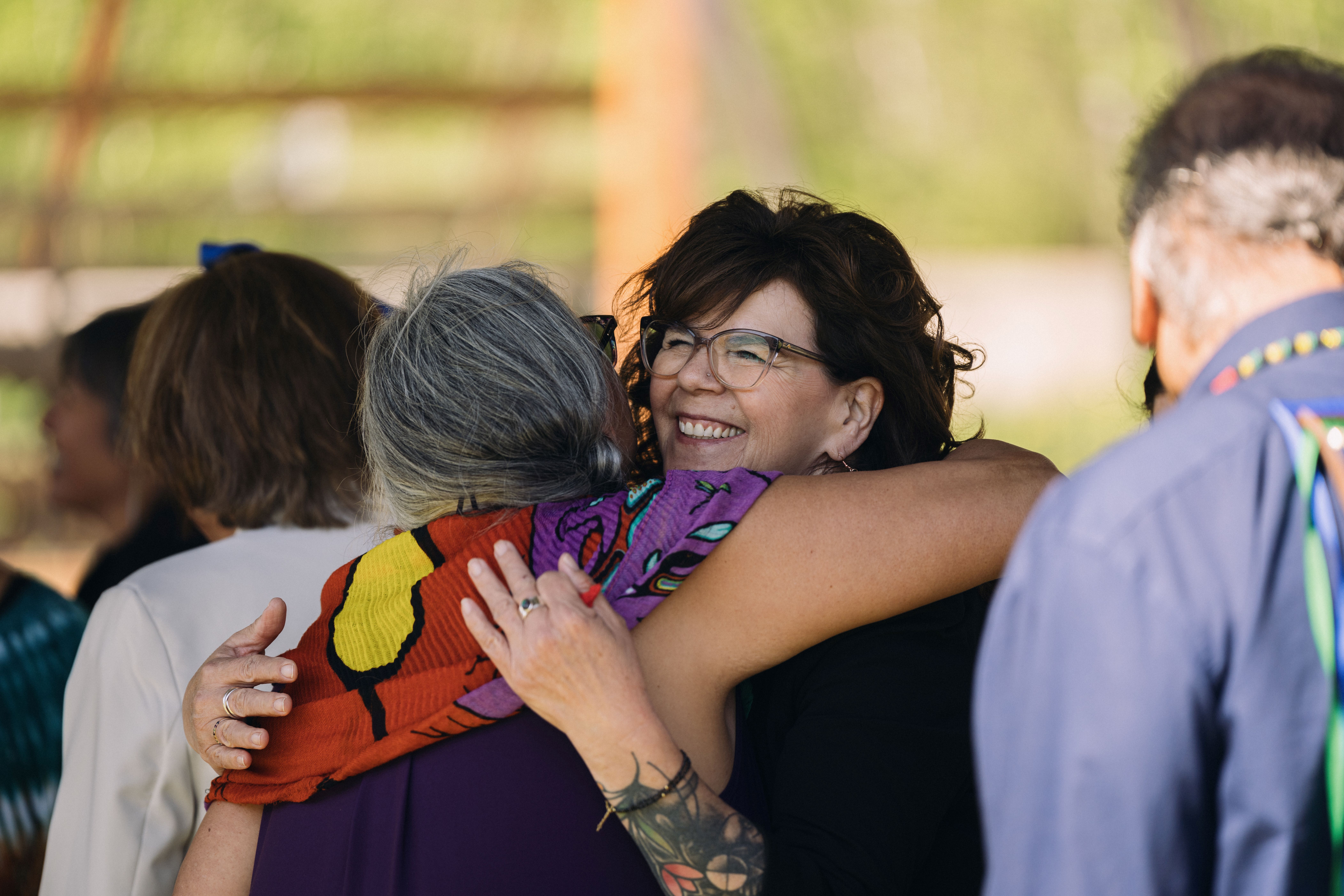 Chief Michele Solomon Embraces a Community Member Chief Michele Solomon embraces a fellow community member at the Lakehead presidential installation ceremony of Dr. Gillian Siddall at Anemki Wajiw on Fort William First Nation