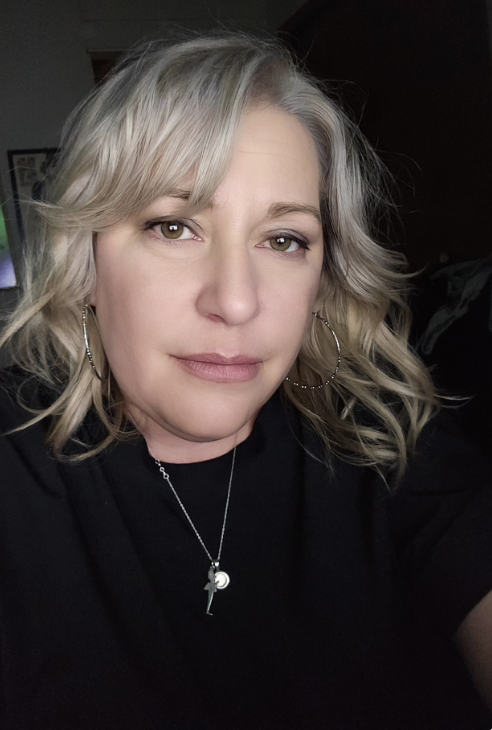 Dr. Amy Junnila Dr. Dr. Amy Junnila wearing a black shirt and a silver pendant