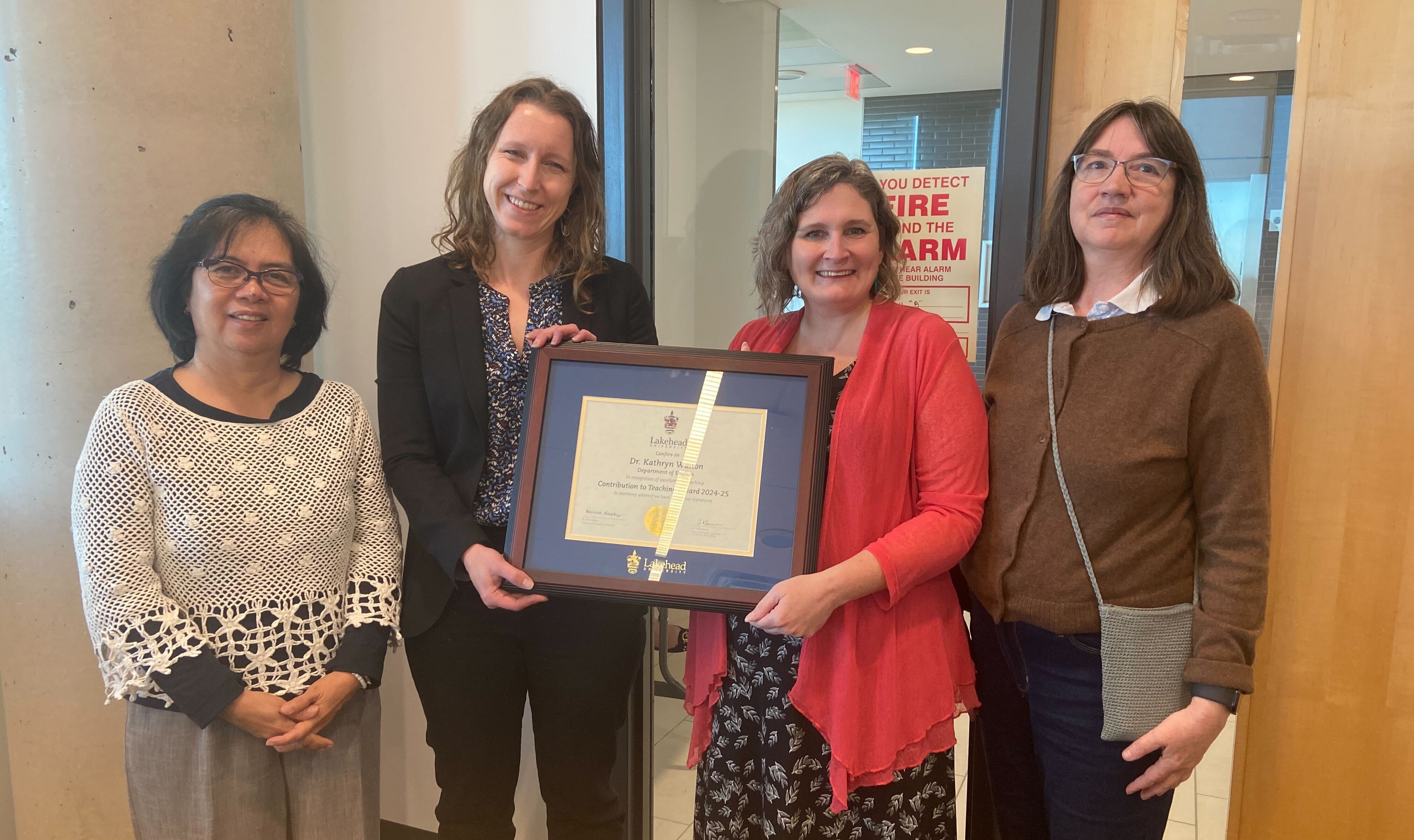 Dr. Kathryn Walton Walton with her 2025 Contribution to Teaching Award Dr. Kathryn Walton accepts her 2025 Contribution to Teaching Award