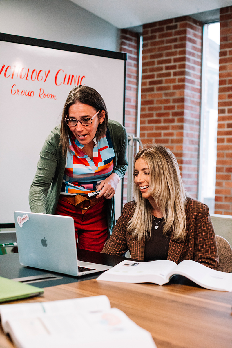 Staff members navigating a computer