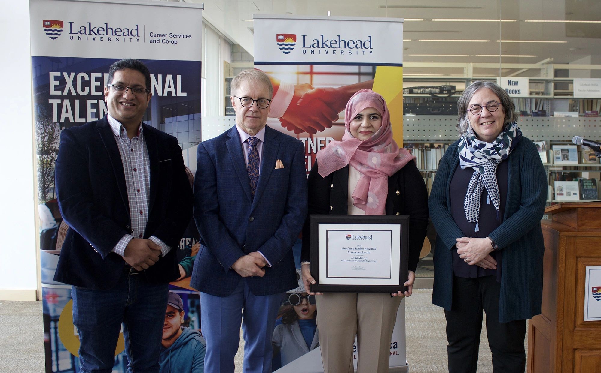 Sana Sharif Accepts Her 2024 Graduate Studies Research Excellence Award Dr. Waled Ejaz, Dr. Andrew Dean, Sana Sharif holding her award certificate, and Dr. Gillian Siddall stand beside each other