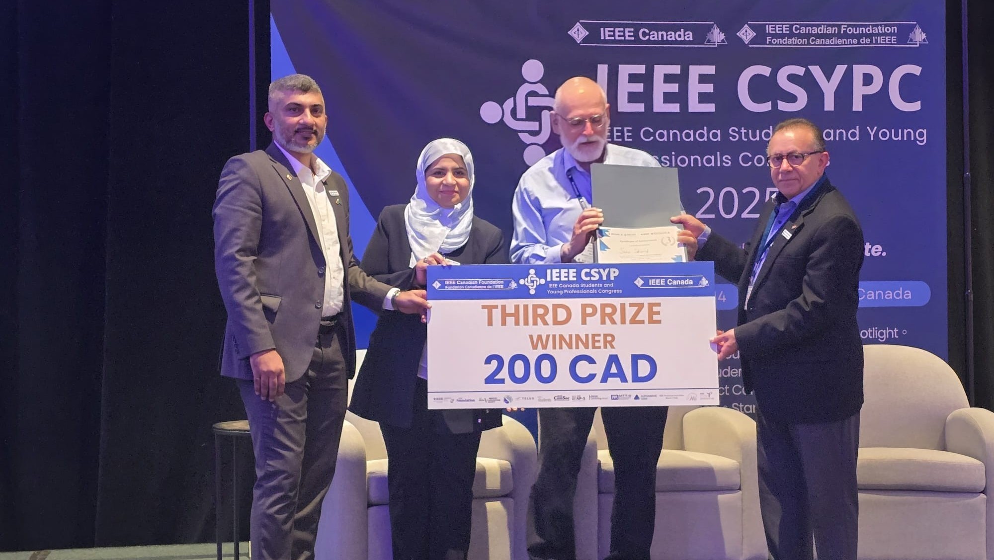 Sana Sharif Receives 2025 IEEE CSYPC Third Prize Sana Sharif accepts a $200 cheque from 2025 IEEE CSYPC officials for winning third place
