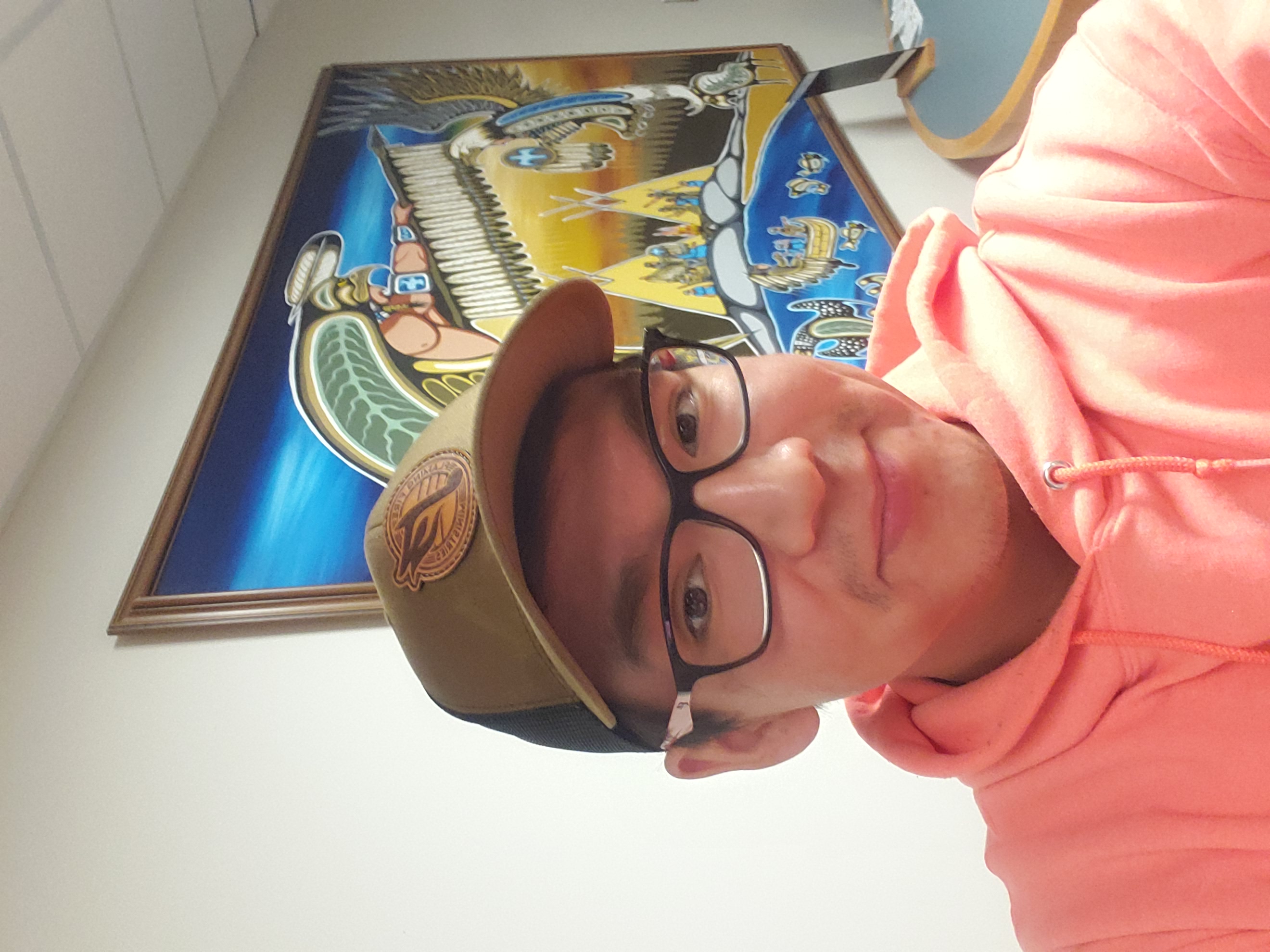 Jared Visitor Lakehead student Jared Visitor with a Woodland painting in the background