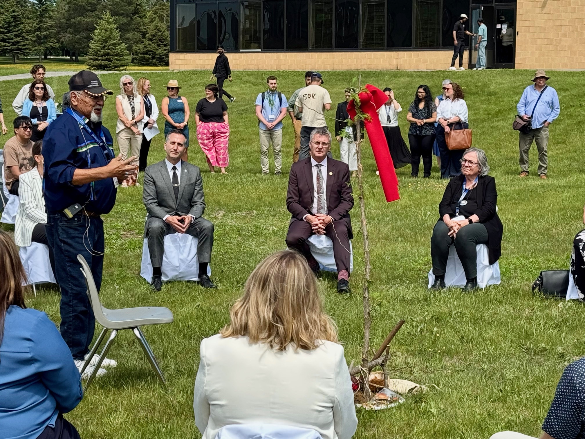 CDVMP Ground Blessing Ceremony An Elder speaks to guests during the CDVMP ground blessing ceremony on the lawn of the Lakehead Thunder Bay campus