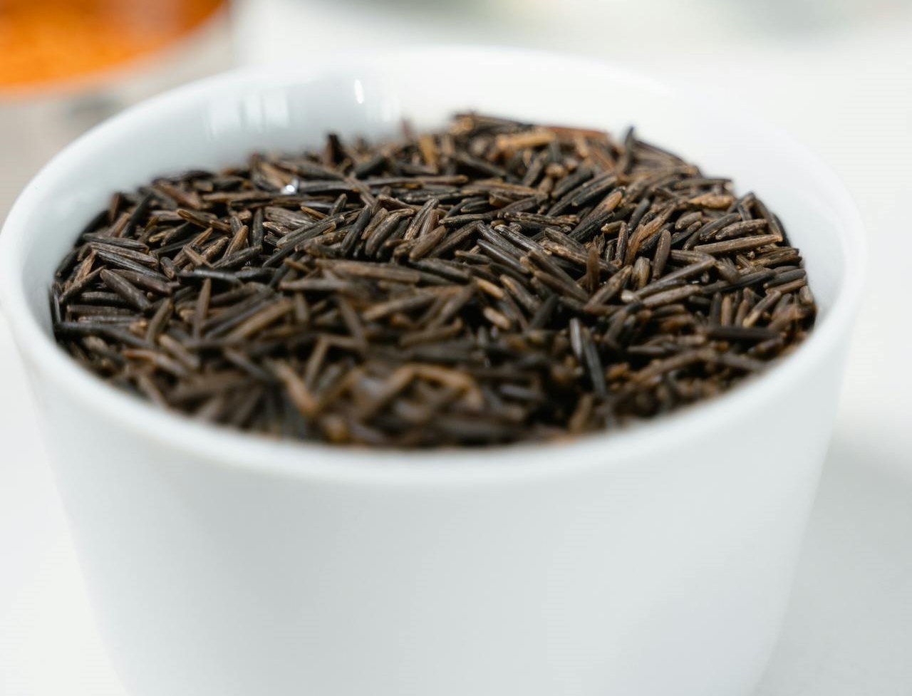 Wild Rice Grains A small bowl of uncooked wild rice grains