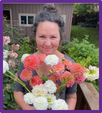 Woman holding flowers with pepper coloured hair