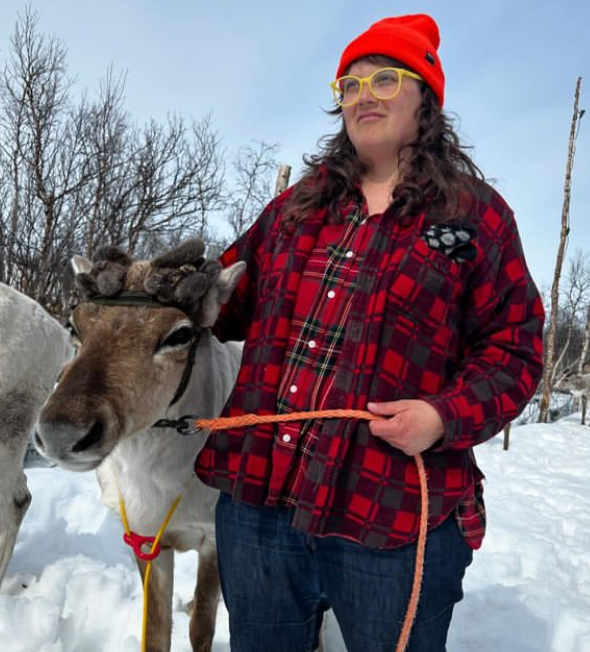 Dr. Leigh Potvin standing beside a Norwegian reindeer