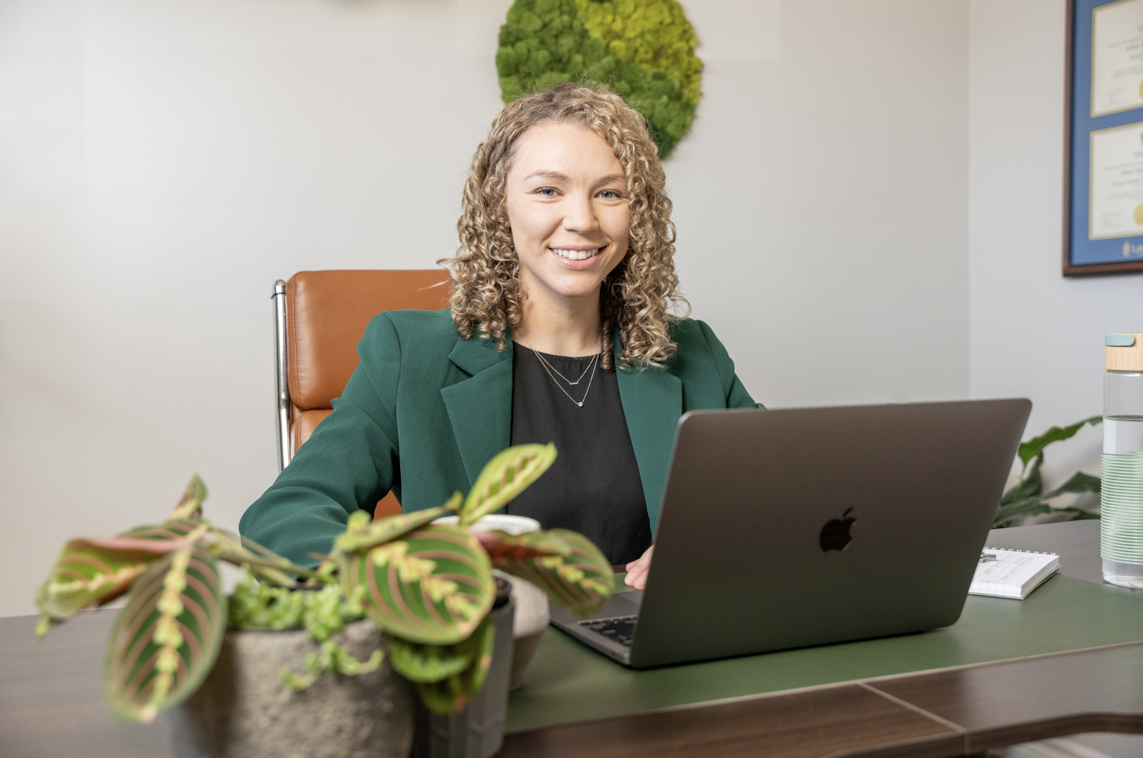 Sidney sitting at a desk with a laptop Sidney sitting at a desk with a laptop