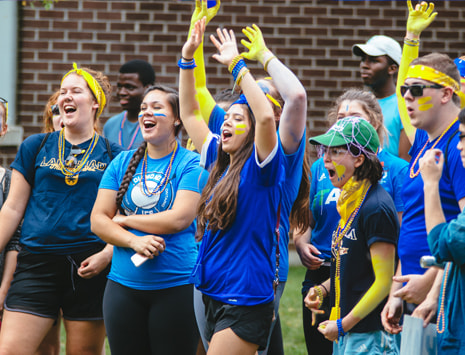 Students cheering outside a residence life event